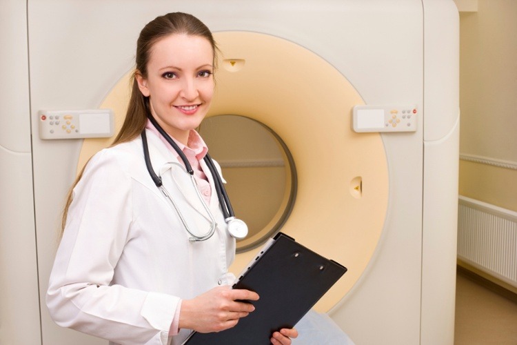 Woman Technologist with CT Scan Machine