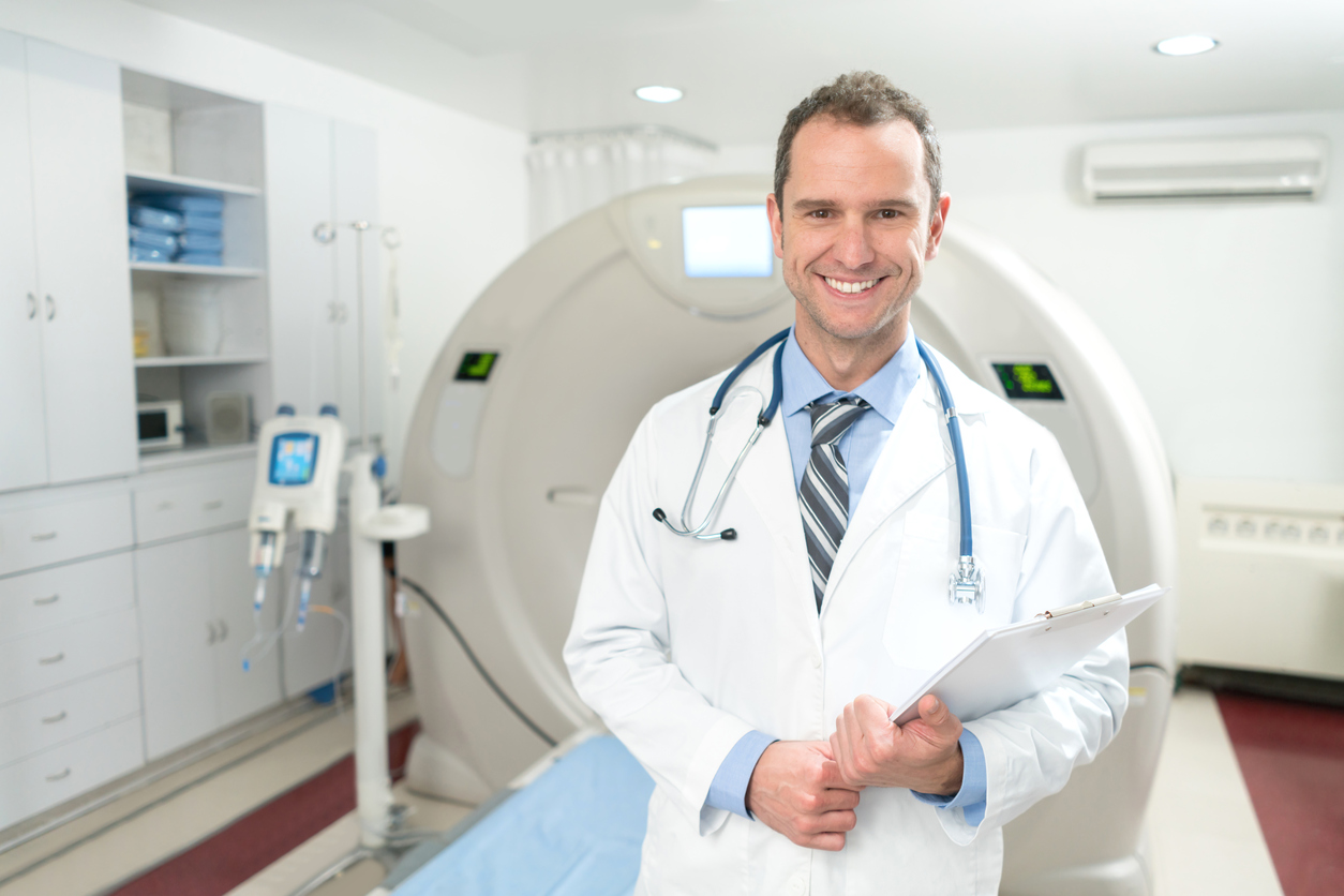 Doctor at a CT scanner room